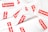 A collection of white plastic bags scattered around, each prominently featuring the red and white Supreme logo. The logo is centered on each bag, creating a repeated pattern throughout the image.