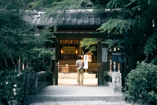 man walking towards brown house in Uji Japan