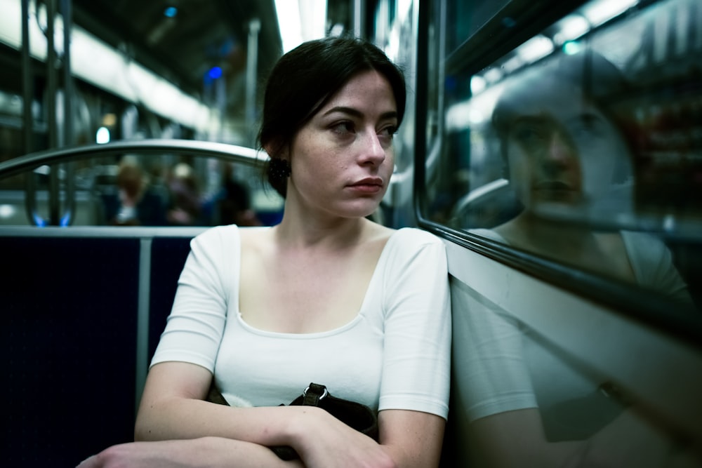 woman sitting inside vehicle with reflection on mirror