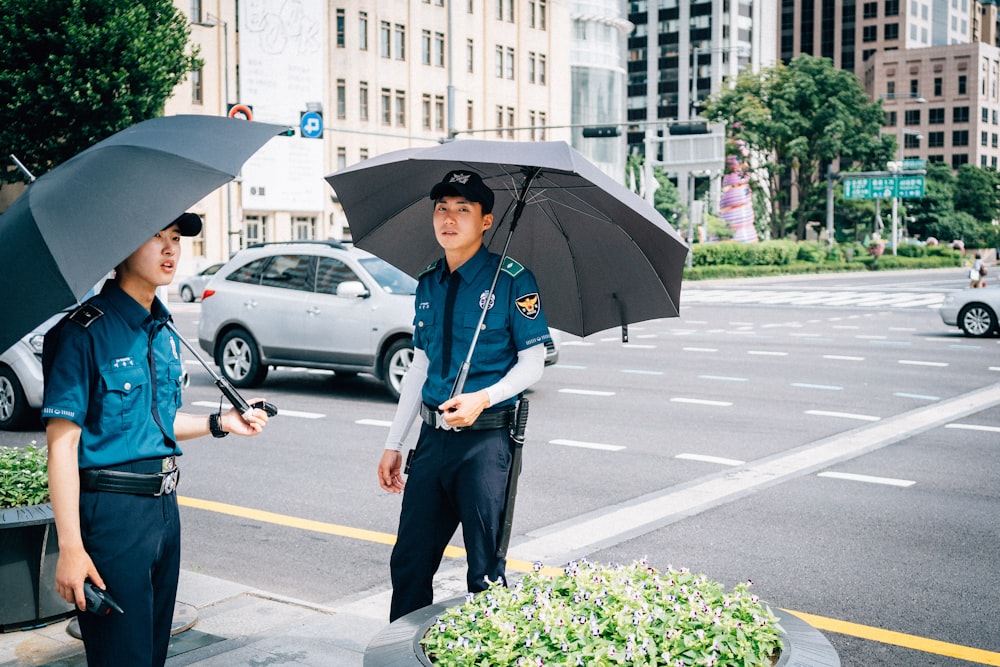 man under umbrella walking on street