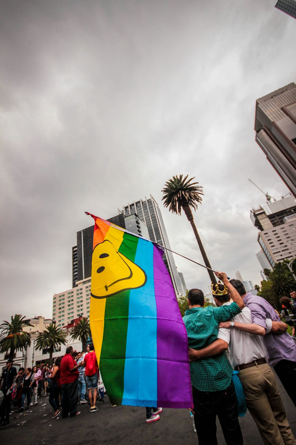 person holding smiley flag