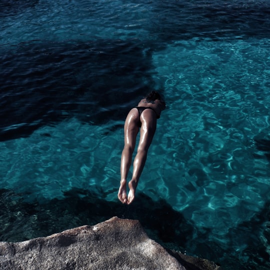 woman diving in ocean in Porto Cervo Italy