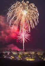 fireworks above houses at night time