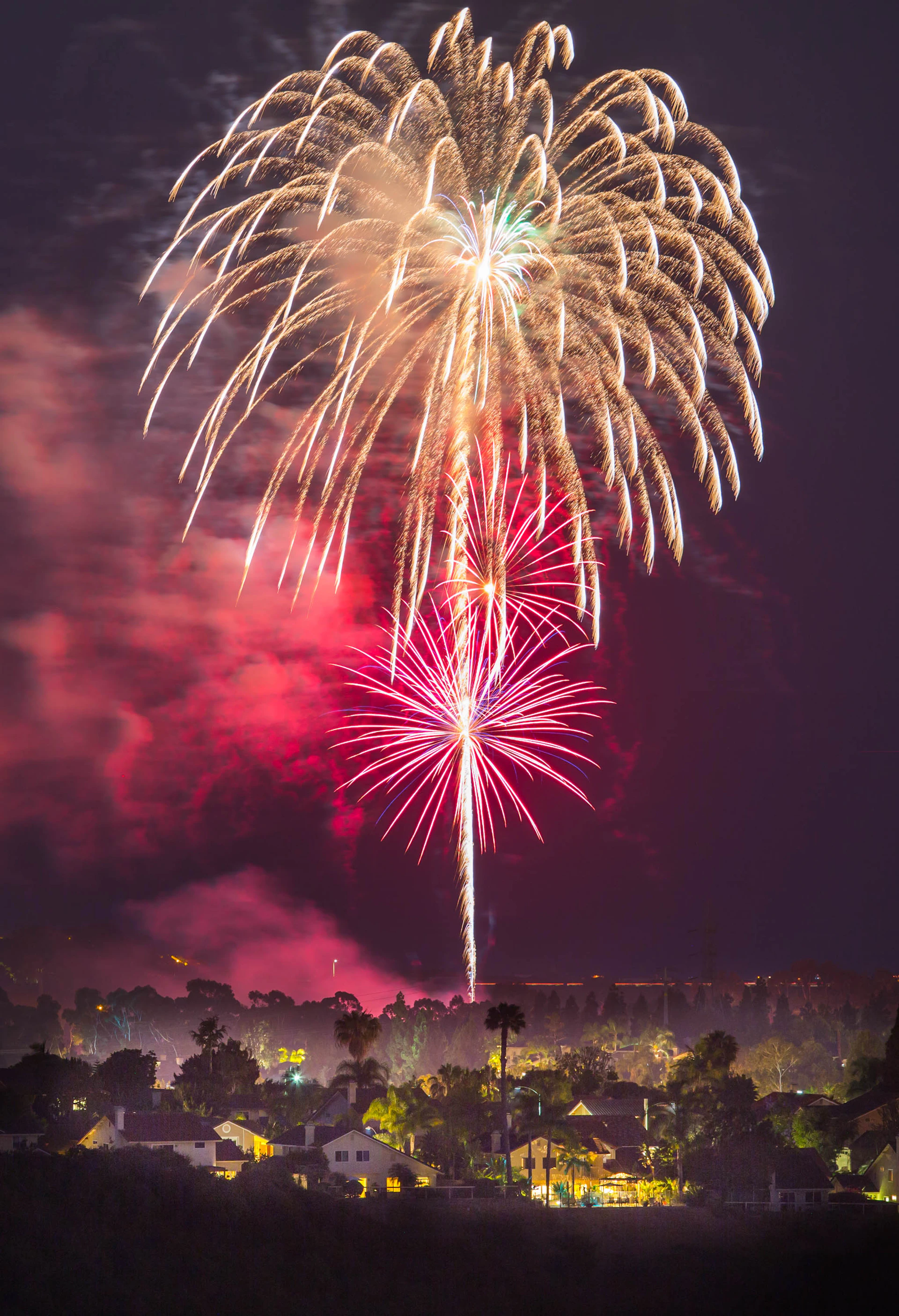 fireworks above houses at night time