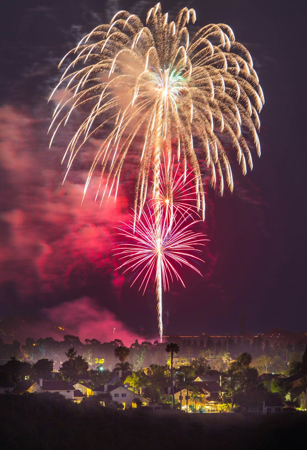 fireworks above houses at night time