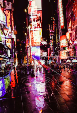 High-tech urban street illuminated by neon signs and digital billboards in cyberpunk style.