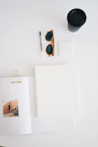 Flat lay of digital ebooks and planners with coffee beans scattered around.