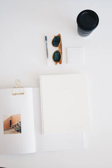 Flat lay of digital ebooks and planners with coffee beans scattered around.
