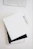 empty spiral notebook near keyboard and pen