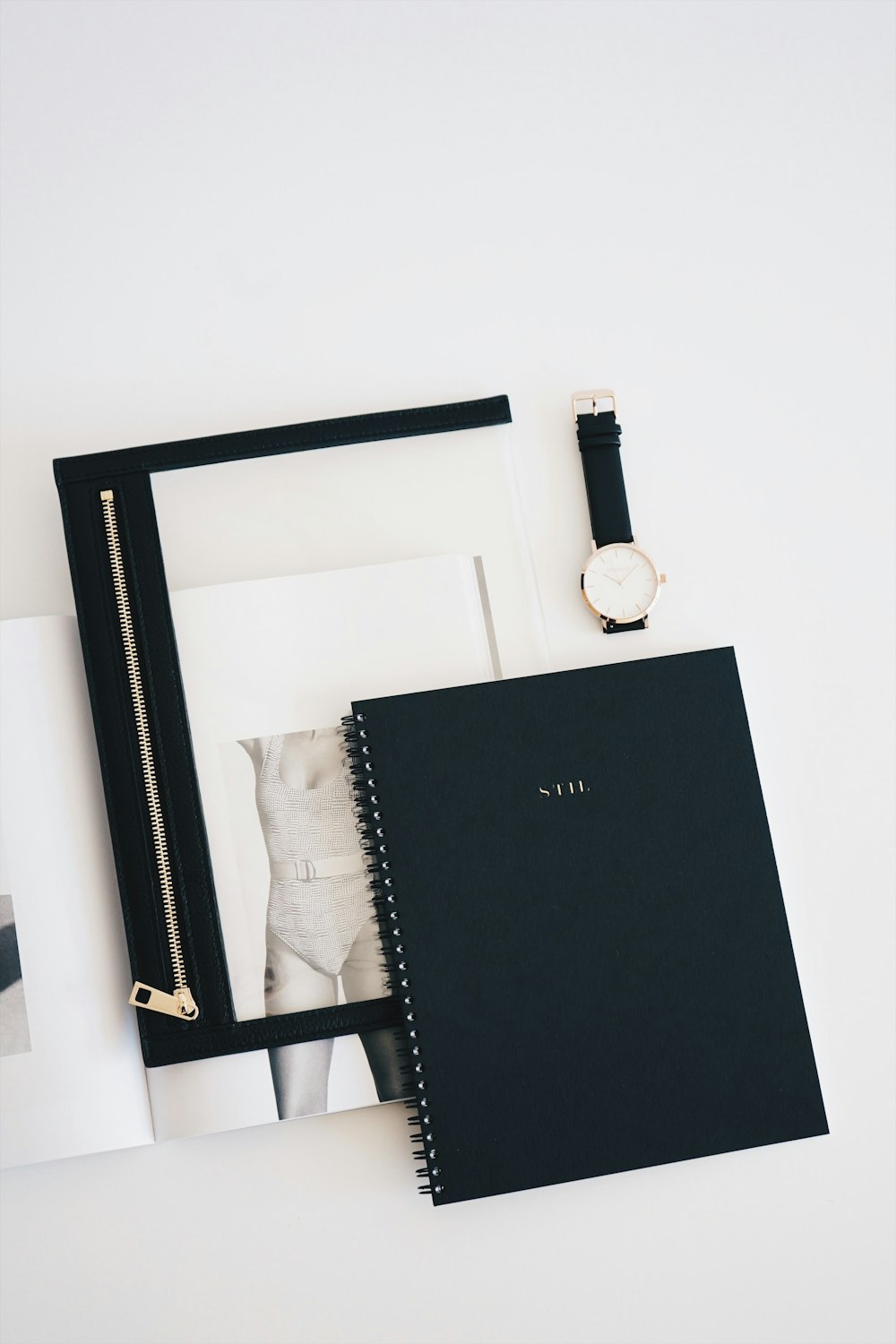 flat lay photo of watch, notebook, and watch