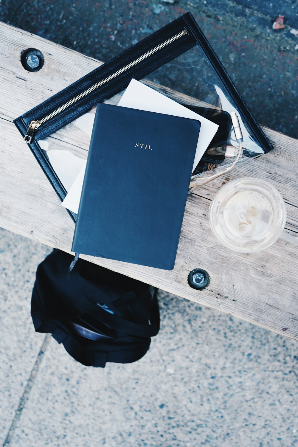 black labeled book on beige wooden surface