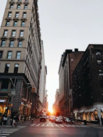 A wide-angle view of the film crew capturing a bustling city street scene at sunset.