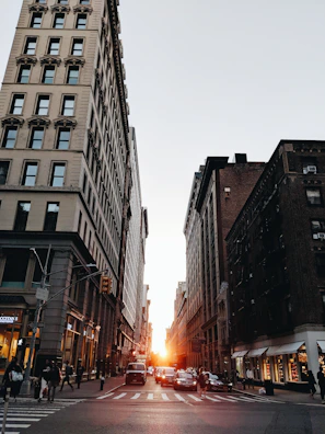 A wide-angle view of the film crew capturing a bustling city street scene at sunset.
