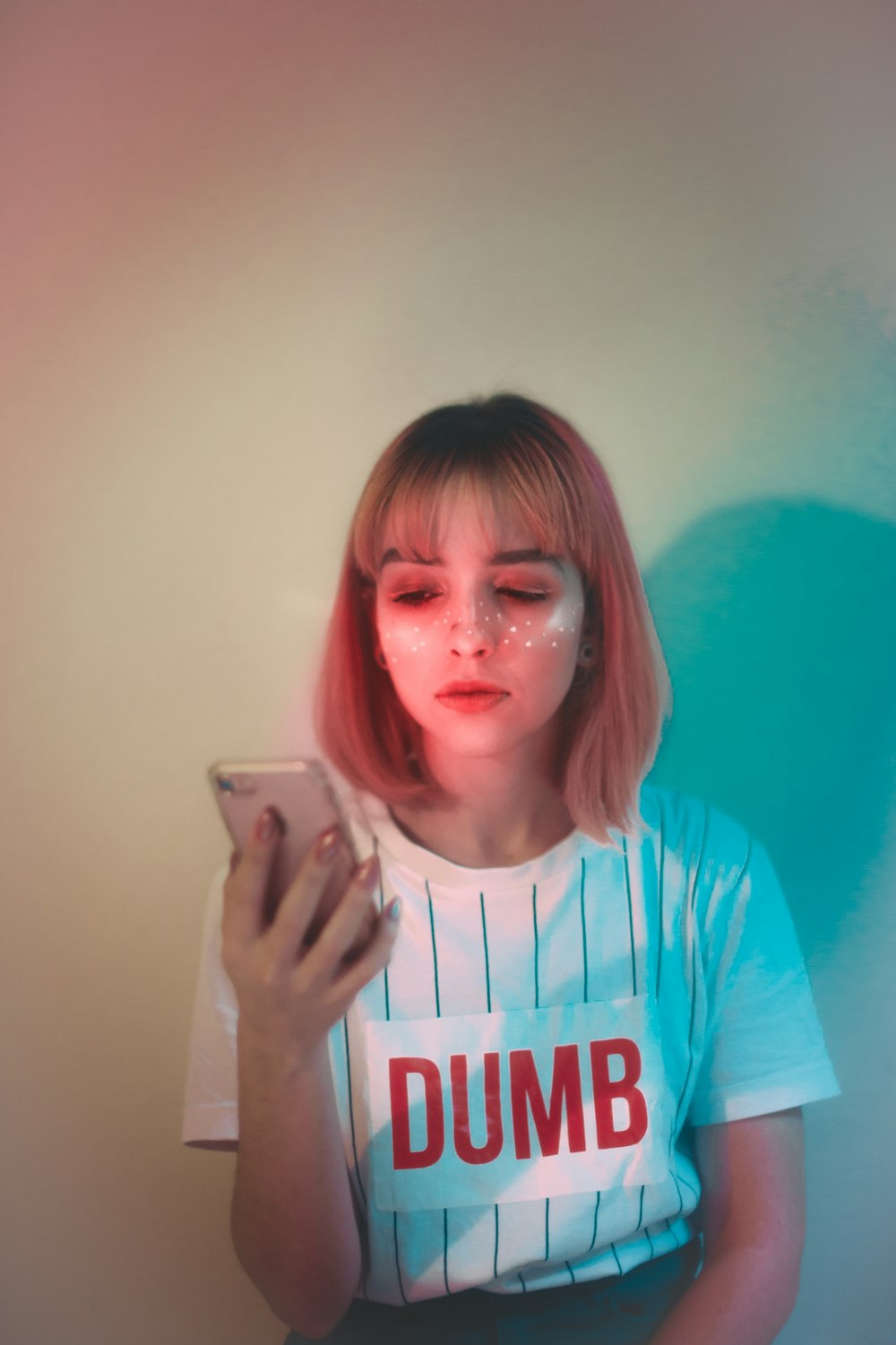 woman using smartphone white leaning on wall