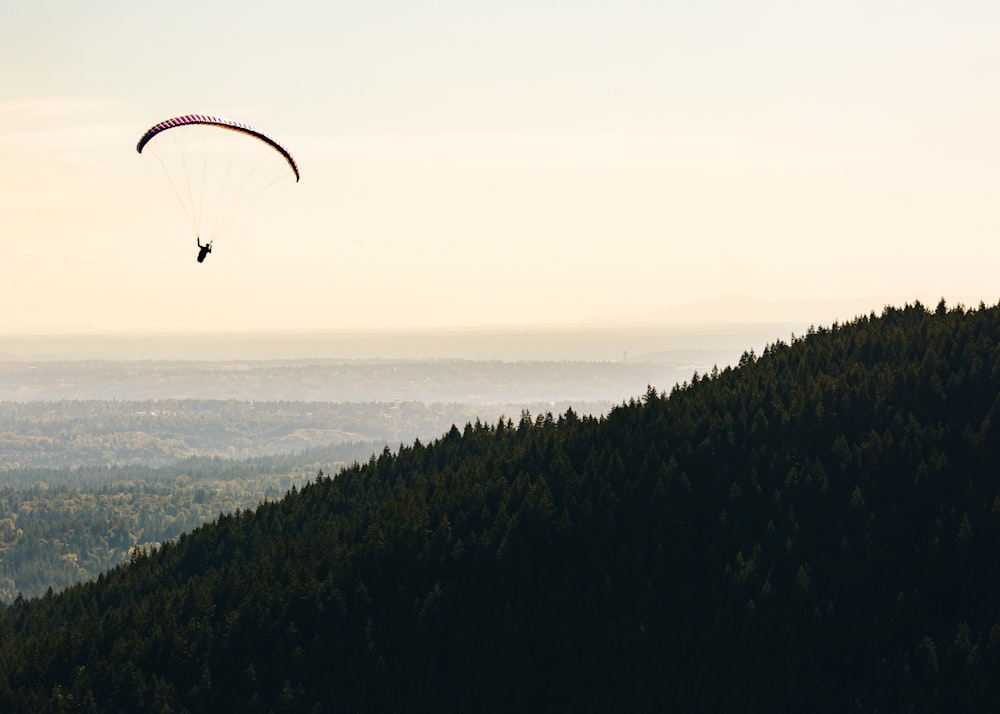 person paragliding near mountain