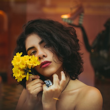woman holding yellow flowers