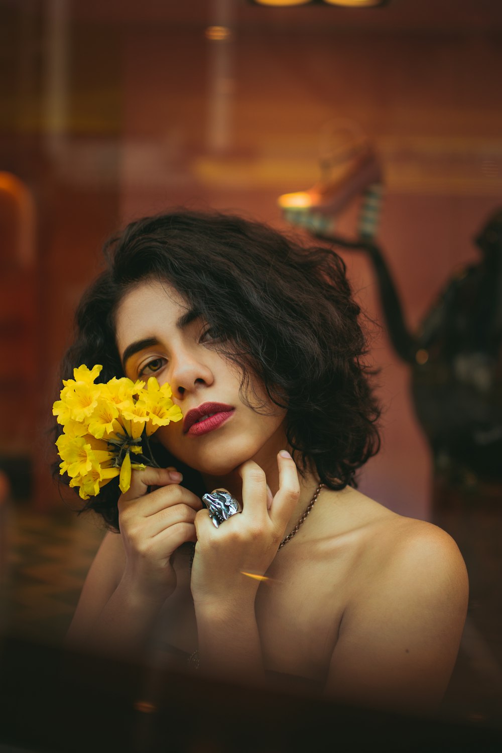 femme tenant des fleurs jaunes