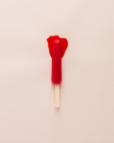 A refreshing ice pop melting slightly in the warm sun.