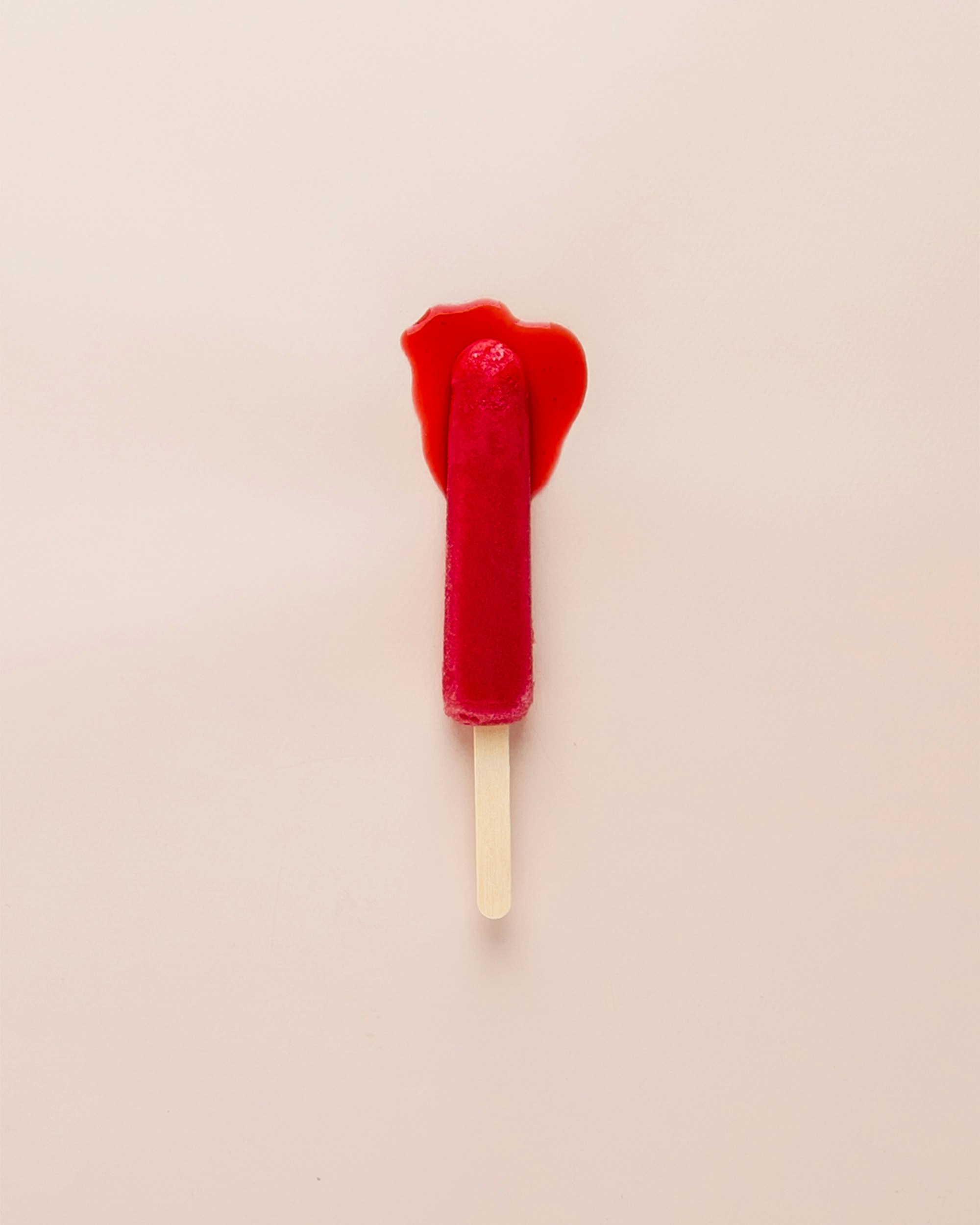 a red popsicle melting to represent period soothing pms symptoms 