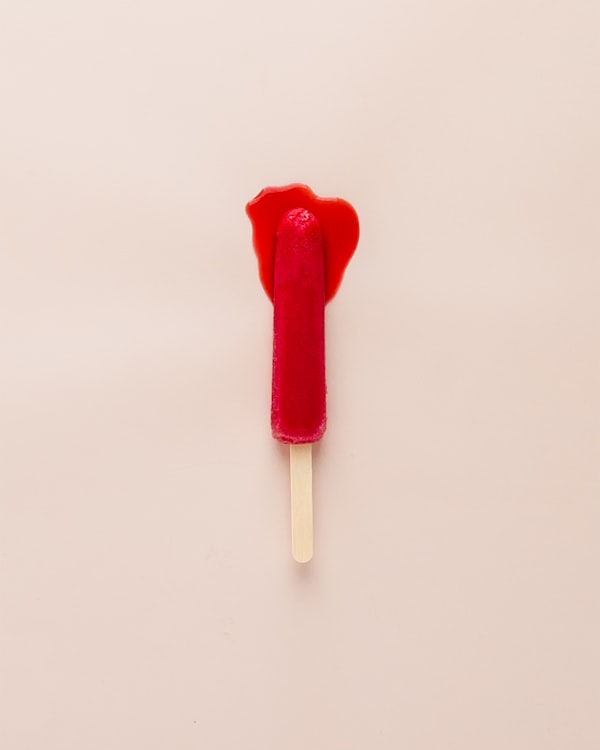 a red popsicle melting to represent period soothing pms symptoms 