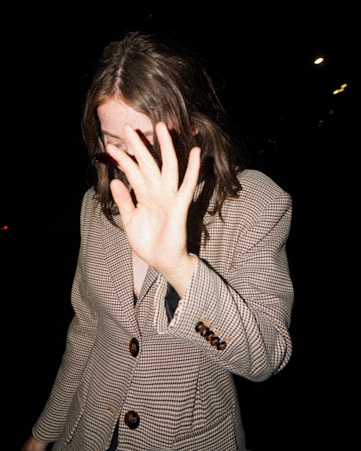 woman covering her face