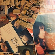 A collage of various posters and flyers, some featuring portraits of people in different poses and expressions, likely from movies or promotional events. The text on the materials appears to be in Japanese, with colorful and diverse visuals.