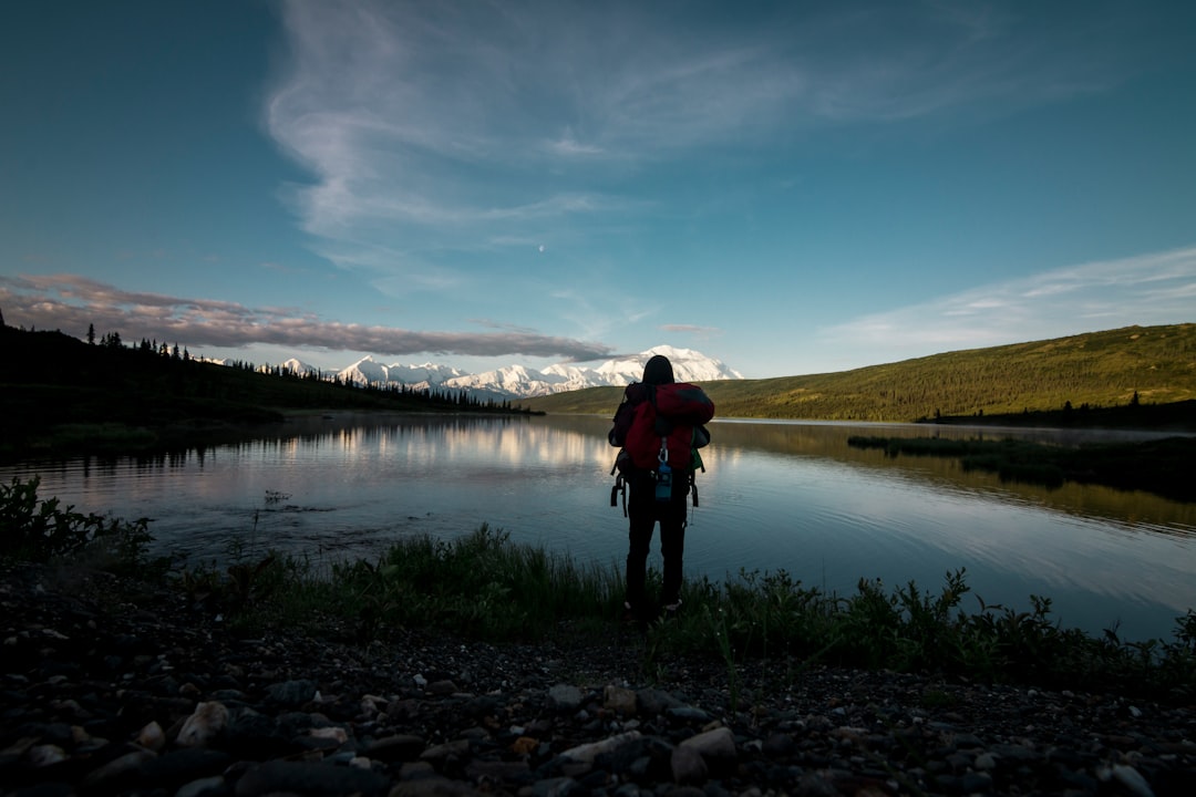 man standing in front of body of water