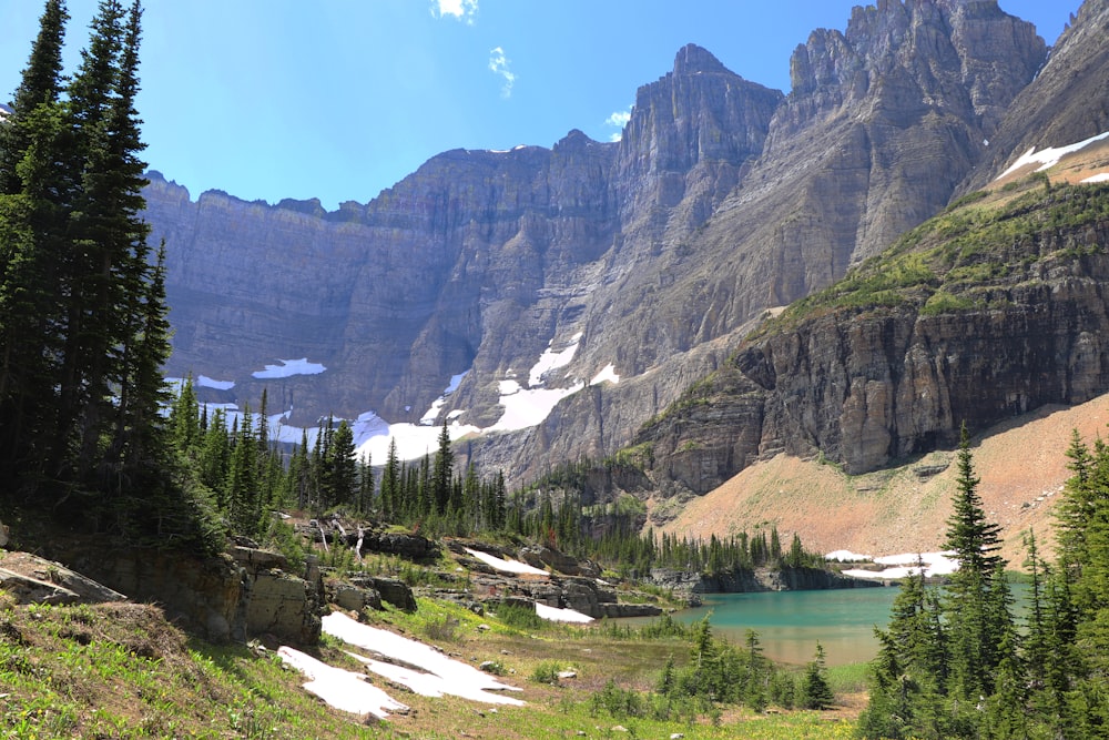 mountains near trees and body of water at daytime