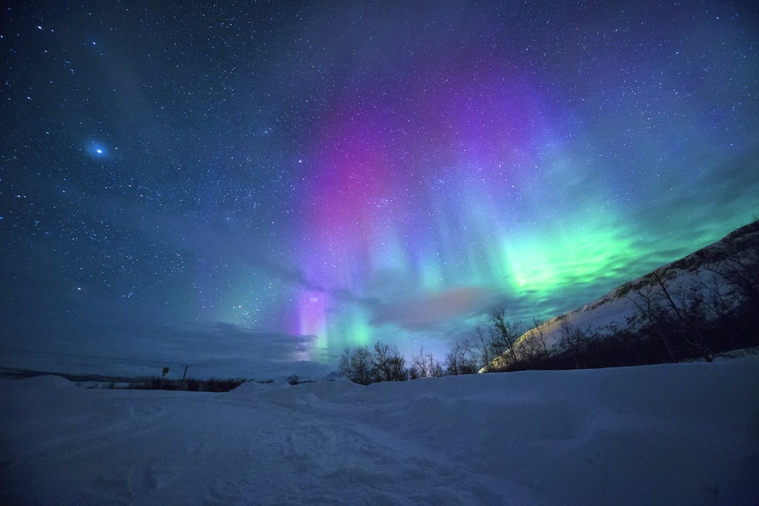 northern lights over snow-capped mountian