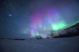 northern lights over snow-capped mountian