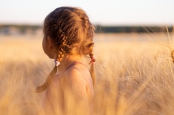 girl wearing pink camisole on brown plant during daytime