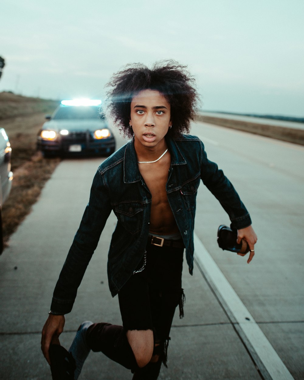 man standing in the middle of highway