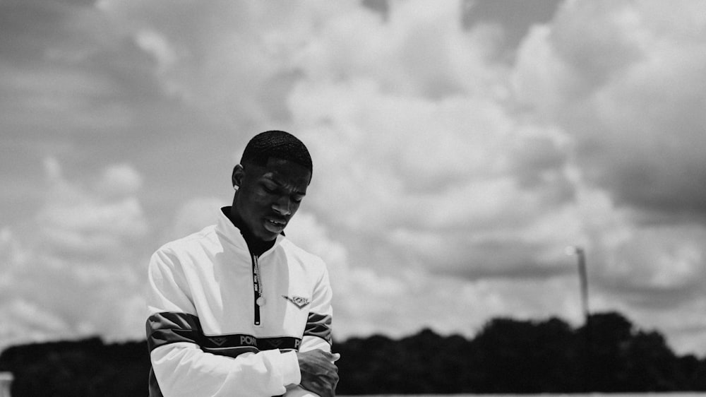 grayscale photography of man crossing his arms