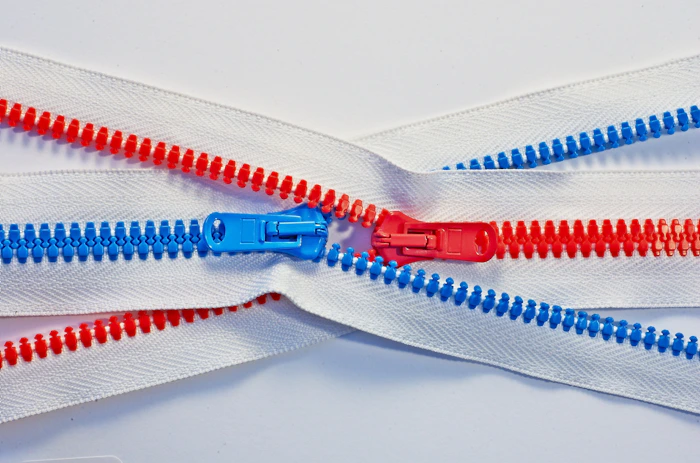 Red and blue YKK zippers meeting