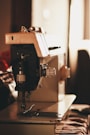 closeup photo of gray and black electric sewing machine