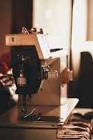 closeup photo of gray and black electric sewing machine