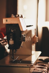 closeup photo of gray and black electric sewing machine
