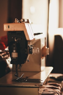 closeup photo of gray and black electric sewing machine