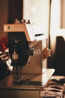 closeup photo of gray and black electric sewing machine