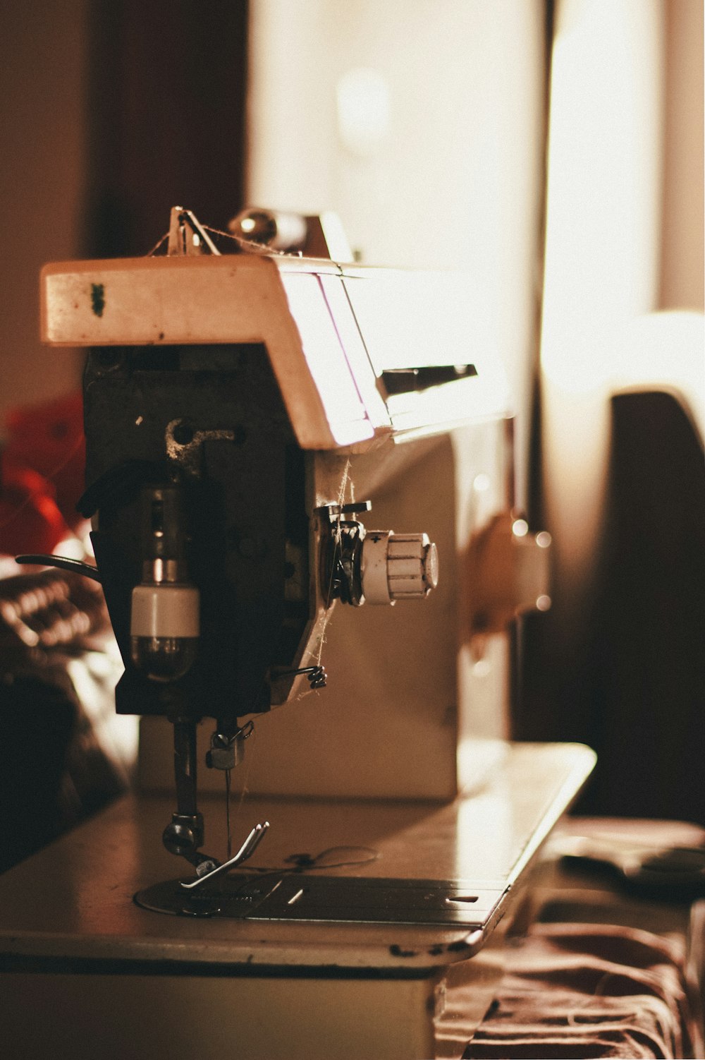 closeup photo of gray and black electric sewing machine