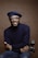 smiling man wearing black turtleneck shirt holding camrea