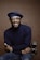 smiling man wearing black turtleneck shirt holding camrea