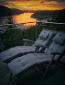 An adjustable backyard recliner positioned perfectly for a sunset view with cozy cushions.