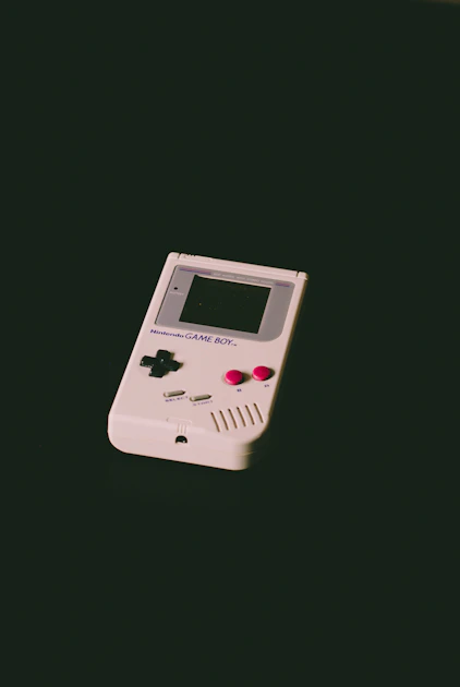 The metal-chassis ModRetro Chromatic handheld playing a Game Boy Color cartridge