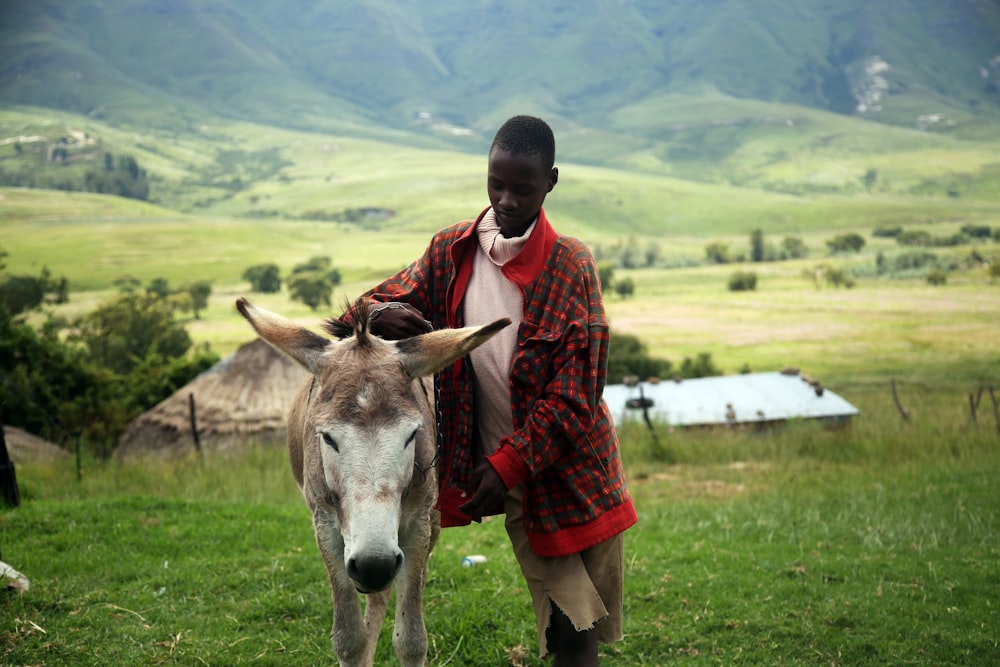 man holding beige horse