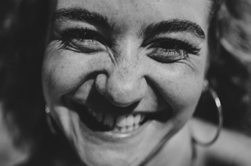 A candid photo of a client celebrating a breakthrough during a lively coaching call with Abbey.