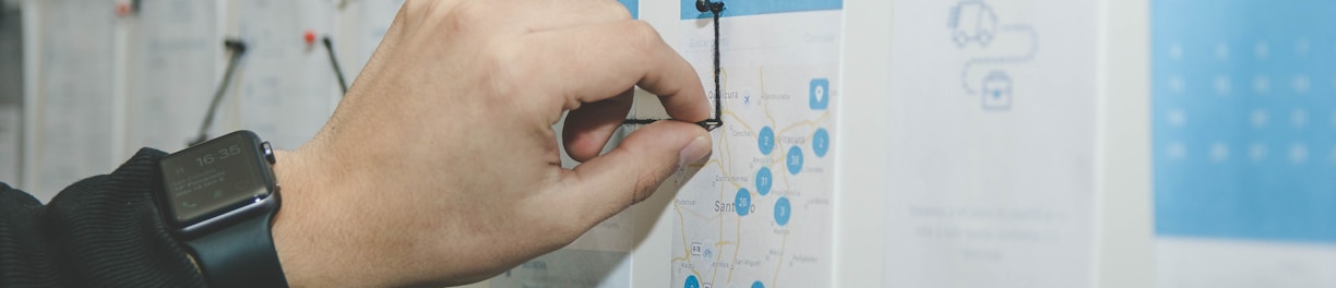 person working on blue and white paper on board