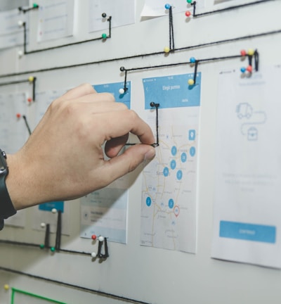 person working on blue and white paper on board