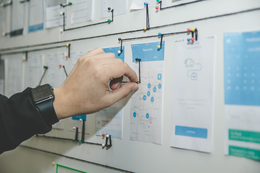 Individual indicating a wall filled with papers, demonstrating how to use enterprise search tools.