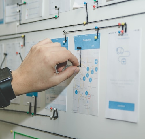 person working on blue and white paper on board